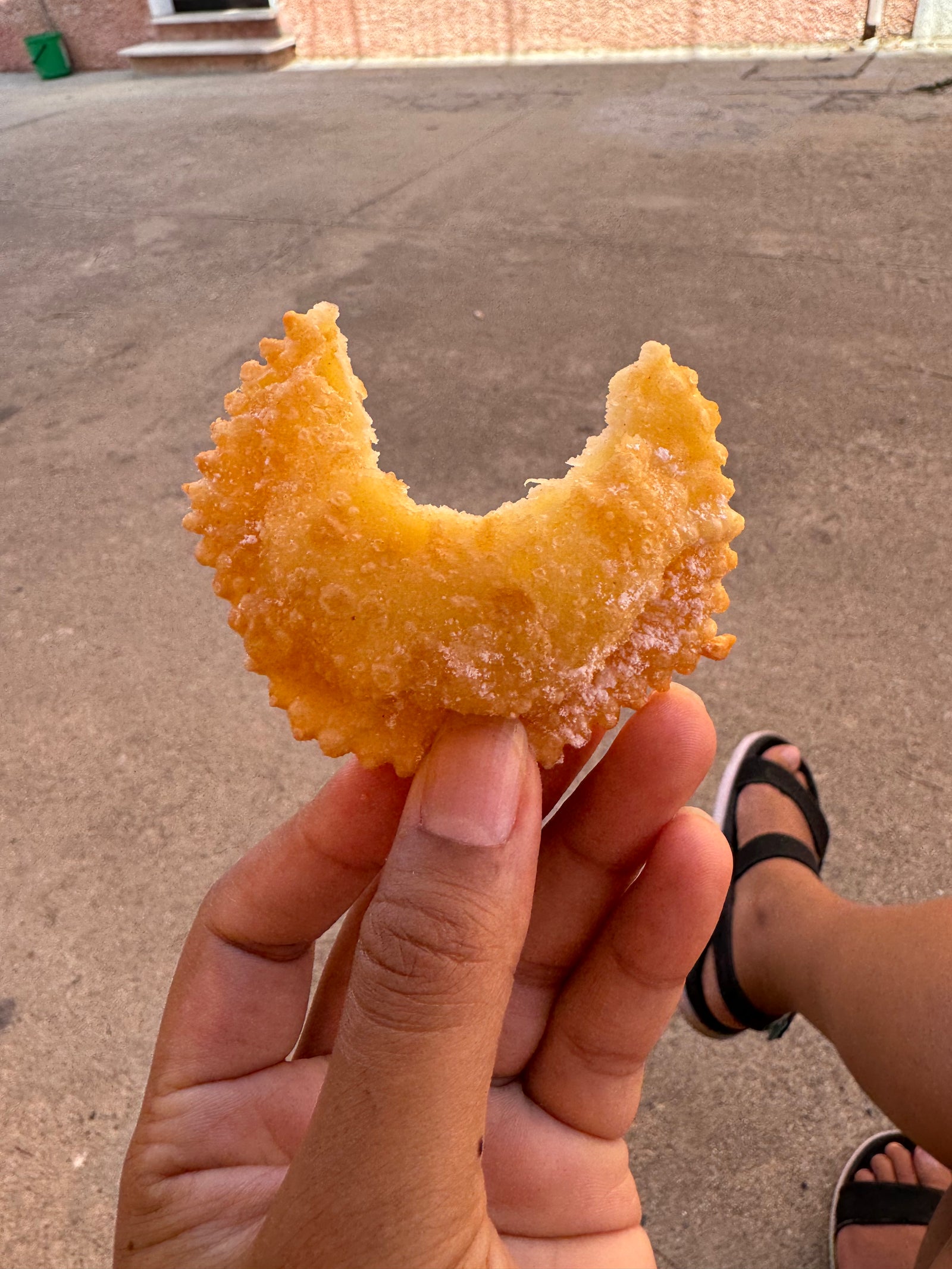 Rania holding a pastry in Sardinia, the reason why she starterd fiboli