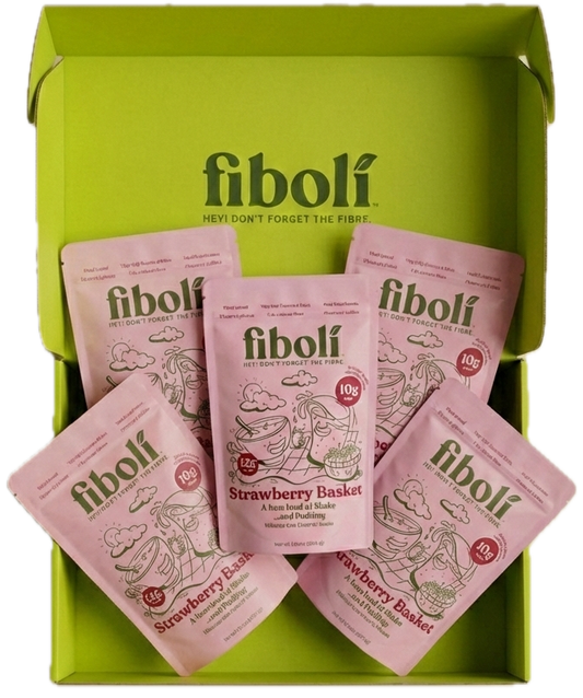 Pink packets of fiboli Strawberry Basket in a green box on a white background