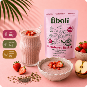 Fiboli Strawberry Basket shake packaging with a glass of shake, bowl, and strawberries on a pink background