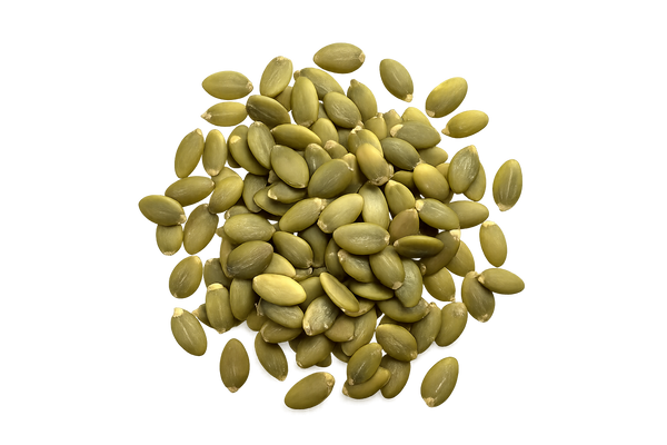 Pile of green pumpkin seeds on a white background