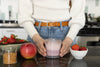 A young woman making a fiboli strawberry shake, Mixing the dry mix with milk into a shaker bottle. 