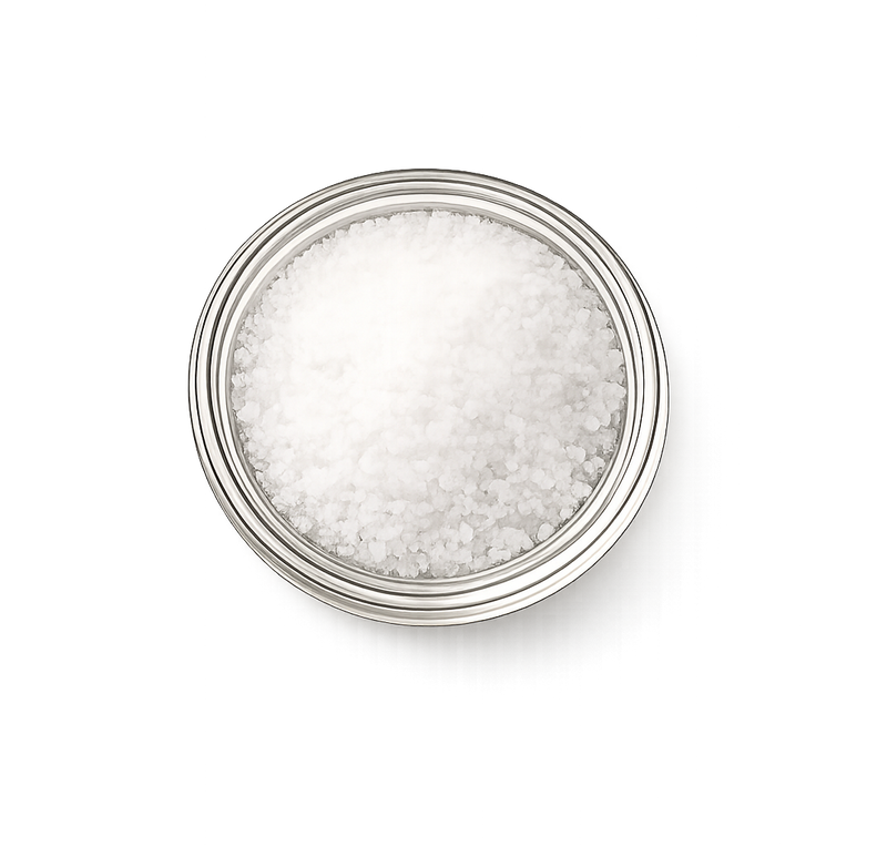 Silver container filled with white granulated sea salt on a white background